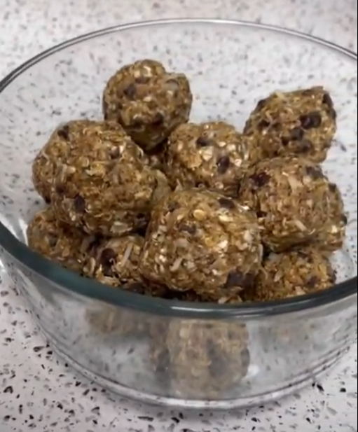 Gluten-Free Energy Bites in a glass bowl on a black and white speckled counter