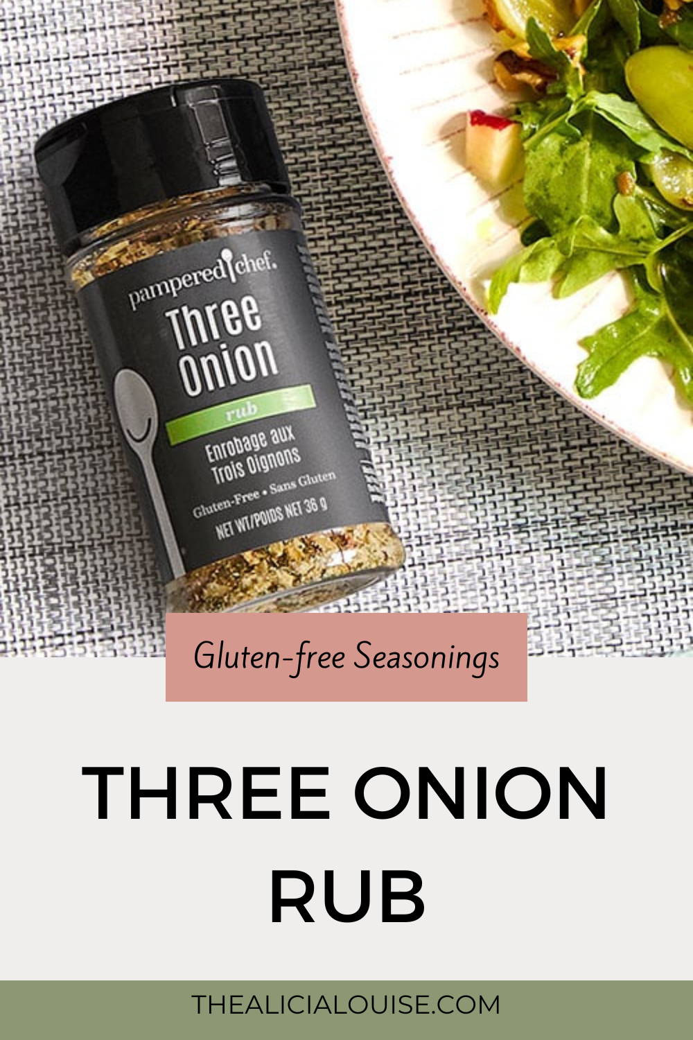 A picture of a bottle of seasoning with the writing Pampered Chef Three Onion Rub on it. The bottle is laying flat on a table with a plate filled with salad on it. writing overlay saying gluten-free seasonings three onion seasoning