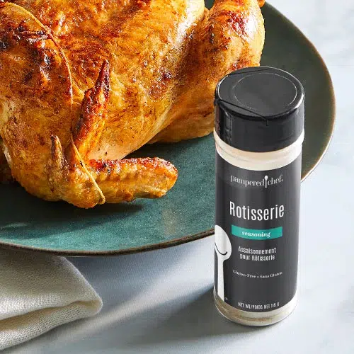 a picture of the pampered chef gluten-free rotisserie seasoning on the table next to a plate with chicken on it
